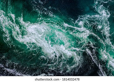 Abstract background. Waves of water of the river and the sea meet each other during high tide and low tide. Whirlpools of the maelstrom of Saltstraumen, Nordland, Norway - Shutterstock ID 1814032478