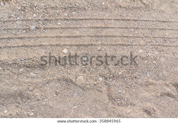 Abstract\
background - the wheel tracks in the\
sand.