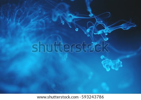 abstract background white drops of milk, soluble in water, blue background