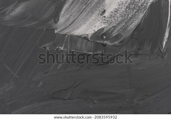 Abstract background. White paint and black ink\
texture. Macro image of spackling paste. Stroke wallpaper for web\
and game design. Drywall mud art. Smear of painterly plaster on\
cardboard.