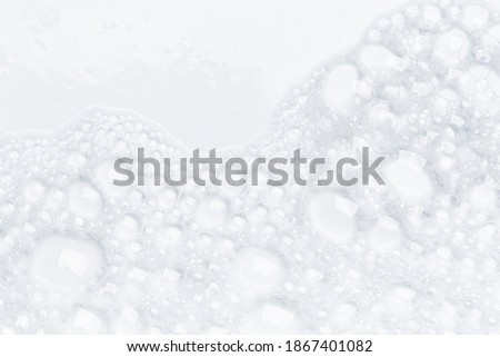 Abstract background white soapy foam texture. Shampoo foam with bubbles