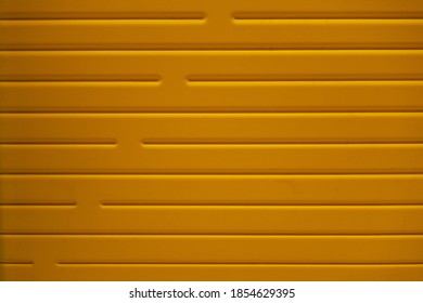 Abstract Background Of Yellow Embossed Plastic Surface Close Up