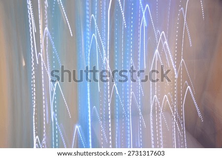 Abstract background with zigzag blue light trails and dynamic motion blur effect on a soft pastel backdrop.