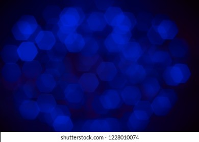 Abstract Beautiful Blurred Electric Blue Hexagon Bokeh From Group Of Blacklight. Background For Mystery Or Sciences Concept.