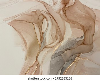 Abstract beige art with gold — pink background with brown, beautiful smudges and stains made with alcohol ink and golden pigment. Beige fluid art texture resembles petals, watercolor or aquarelle.


