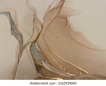 
Abstract beige art with gold — pink background with brown, beautiful smudges and stains made with alcohol ink and golden pigment. Beige fluid art texture resembles petals, watercolor or aquarelle.

