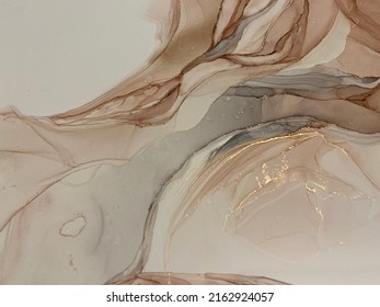 
Abstract beige art with gold — pink background with brown, beautiful smudges and stains made with alcohol ink and golden pigment. Beige fluid art texture resembles petals, watercolor or aquarelle.

