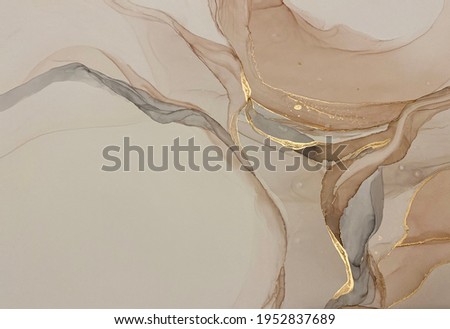 Abstract beige art with gold — pink background with brown, beautiful smudges and stains made with alcohol ink and golden pigment. Beige fluid art texture resembles petals, watercolor or aquarelle.