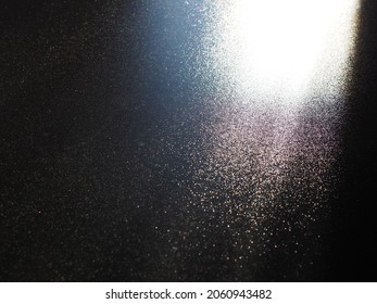 Abstract Black Background. Oblique Light Rays On A Black Blackdrop With Flickering Dots. From Right Top, The Lines Are Directed Down And To The Left. Glow, Flare Or Shine. Side Lighting. Small Glow