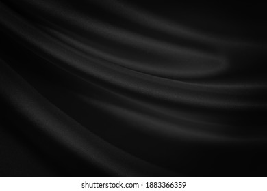  Abstract black background. Black silk satin texture background. Beautiful soft folds on the fabric. Black elegant background with copy space for your design.                              