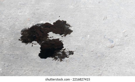 Abstract Black Engine Oil Drop On Concrete Floor Texture Backgruond.
Automobile Garage Dirty Old Oil Stain Cement Pattern.  