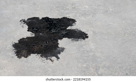 Abstract Black Engine Oil Drop On Concrete Floor Texture Backgruond.
Automobile Garage Dirty Old Oil Stain Cement Pattern.  