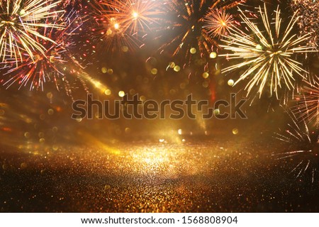 abstract black and gold glitter background with fireworks. christmas eve, 4th of july holiday concept