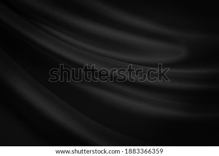  Abstract. Black silk satin texture background. Curtain, drapery. Beautiful soft folds on the fabric. Elegant luxury background with space for design.                              