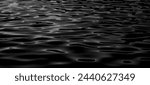 Abstract Black Water Surface. Water reflection texture background. black sea wave.  River lake rippling Water.Ocean surface dark nature background. Dark water. Oil Ripple. Oil Surface. Dark Liquid. 