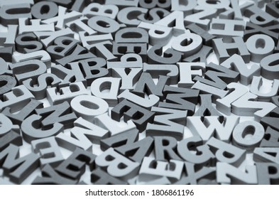 Abstract black and white background of wooden letters of the Latin alphabet. Concept: back to school, literacy and reading, language learning. Selective focus