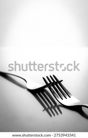 Abstract black and white shadow pattern created by crossed forks