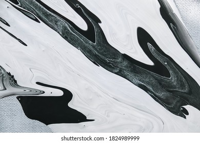 Abstract black and white stains of acrylic paint on canvas. Abstract paint washes, contemporary art.