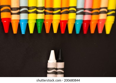 abstract black and white versus colored crayons