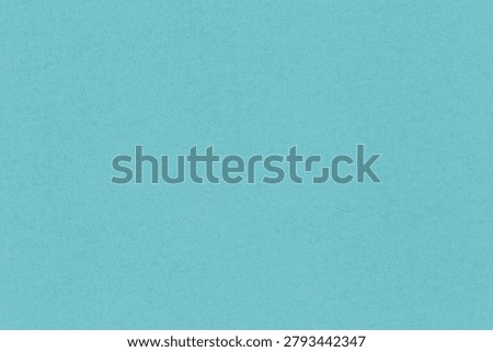 abstract blank turquoise backdrop: close up of speckled craft cardboard texture