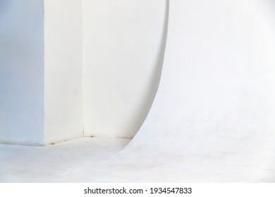 Abstract blank white photo studio interior, cyclorama structure with a smooth transition between horizontal and vertical planes. Background photo