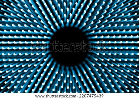 Abstract blue background of concentric glowing dots with blur