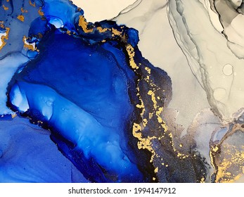 Abstract blue background with gold — beautiful smudges and stains made with alcohol ink and golden metallic. Fragment of art with ultramarine texture resembles watercolor or aquarelle painting. - Shutterstock ID 1994147912