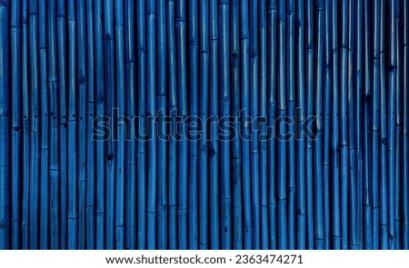 abstract blue bamboo wall for japanese mood decoration, interior or exterior design. old blue bamboo plank fence texture used as background with blank space for design.