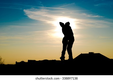 abstract blue clouds and sunset background silhouette of men and women