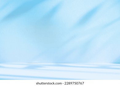 Abstract blue color gradient studio background for product presentation. Empty room with shadows of window and flowers and palm leaves . 3d room with copy space. Summer concert. Blurred backdrop.