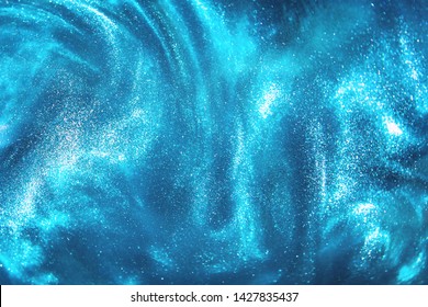 Abstract blue glitter shimmering magic underwater space bokeh background. Festive winter snowstorm. de-focused - Shutterstock ID 1427835437