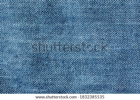 Abstract blue jeans fabric texture and background. Detail of jean textile material.