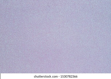 Abstract blue pink pearl glitter paper background, close up. Gradient glitter background from wrapping paper. Metallic shimmers paper card. Flying dust particles on white paper