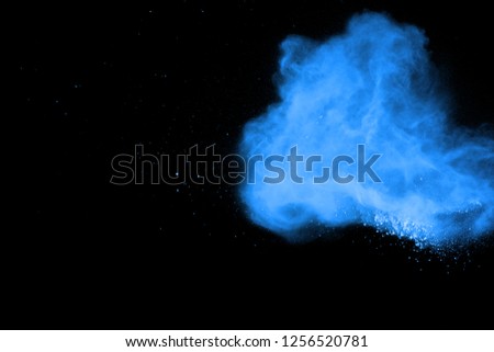 abstract blue powder splatted background. Colorful powder explosion on black background. Colored cloud. Colorful dust explode. Paint Holi.