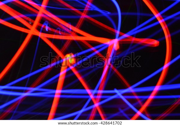 Abstract blue and red streaks of light on\
a black dark background creates a unique\
pattern.