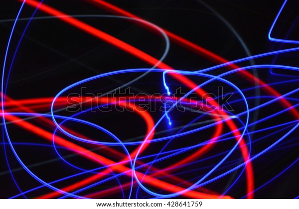 Abstract blue and red streaks of light on
a black dark background creates a unique
pattern.