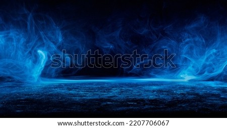 Abstract blue smoke moves on black background.Beautiful swirling blue smoke. Mockup for your logo. Wide angle horizontal wallpaper or web banner.