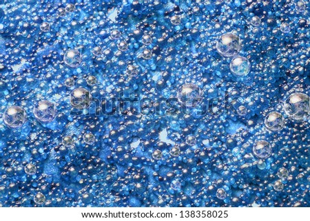 abstract blue spacy background with small blue translucent pellets and globes