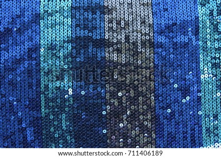 Abstract blue spangles background. Fabric texture with bright blue  circles beads or sequins.