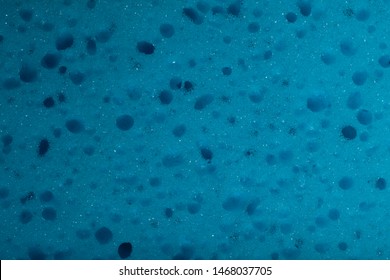 Abstract blue sponge texture background. Cropped shot, close-up, top view, horizontal, no people, free space. Design concept.