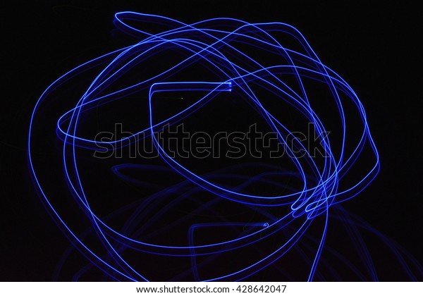 Abstract blue streaks of light on a black dark\
background creates a unique\
pattern.