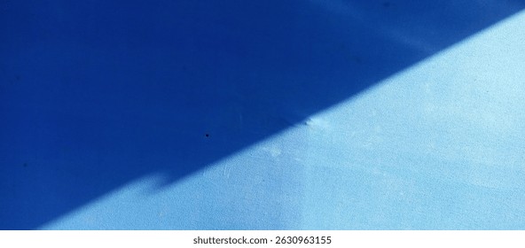 Abstract Blue Surface with Diagonal Shadow and Light Play