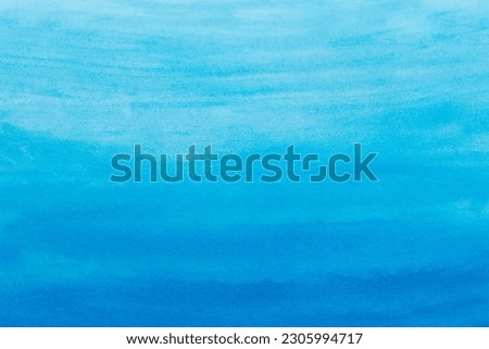 Abstract blue watercolor background. The color splashing on the paper. Hand drawn.
