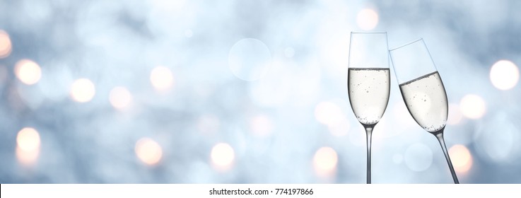 Abstract blue winter background with champagne and golden bokeh for a new year