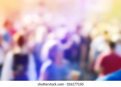 Abstract Blur Audience Crowd Of People At Public Outdoors Place Or Gathering, Social Event Background, Vivid Colors, Defocus Image.