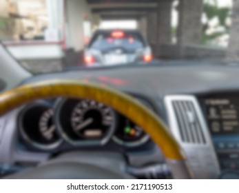 Abstract Blur Background Of Drivers View While In Drive Thru Line.