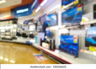 Abstract Blur Background of Eletronic Department Store or Retail Store. TV or Television shelf Shopping Display
