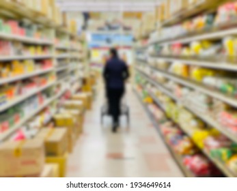 Abstract Blur Background Of A Grocery Store Shopper Walking.