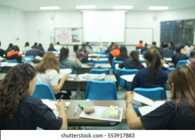 Abstract Blur Background Of  Student During Study Or Quiz,  Test And Exams From Teacher Or In Large Lecture Room / University Classroom.