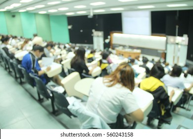 Abstract Blur Background Of Student During Study Or Quiz, Test And Exams From Teacher Or In Large Lecture Room / University Classroom.
